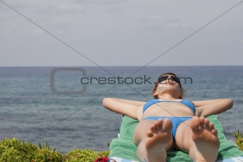 woman sunbathing on chaise