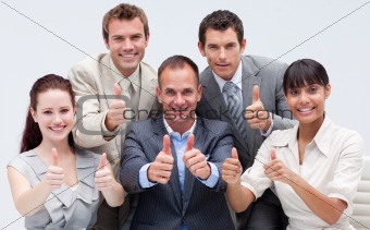 Happy business team with thumbs up