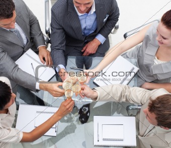 Close-up of business team toasting with champagne