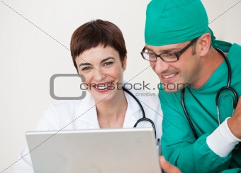 Doctor and surgeon looking at a laptop