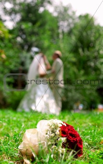Newly-weds in summer, wedding bouquet
