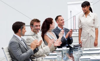 Businessman applauding a colleague after giving a presentation