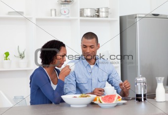 Smiling couple having breakfast together