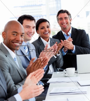 Team of successful multi-ethnic business people applauding