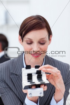 Attractive businesswoman consulting her business card holder