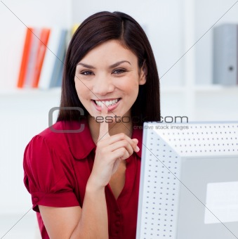 Close-up of a smiling businesswoman askig for silence 