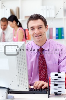 Portrait of a confident businessman working at his computer 