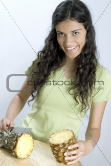 girl cutting pineapple