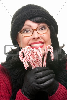 Pretty Woman Holding Candy Canes Isolated on a White Background.
