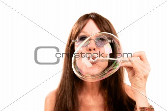 Pretty woman with long hair blowing bubble