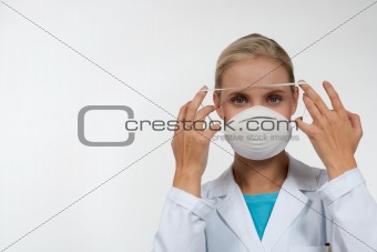 Young female doctor wearing a protecting mask