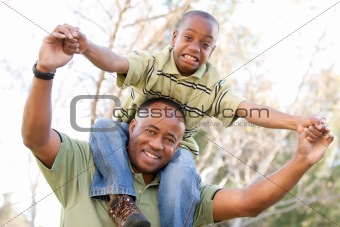 African American Man and Child Having Fun in the Park.
