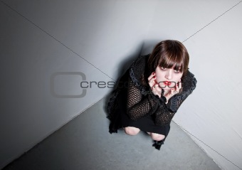 Goth girl in a corner