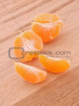 tangerine segments on wooden background