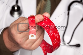Doctor with Stethoscope Holding Red Measuring Tape.