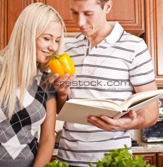 Young Woman Smelling Pepper Held by Young Man