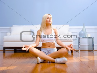 Young Woman Sitting on Wood Floor Meditating