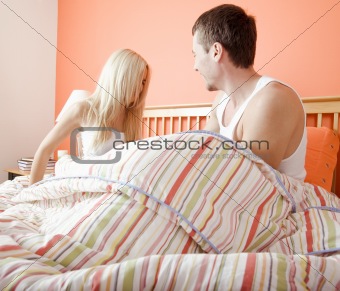 Young Couple Sitting Up in Bed
