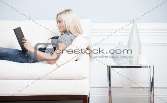 Woman Reclining on Couch With a Book