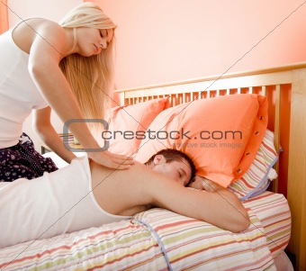 Woman Massaging Man on Bed