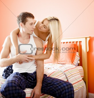 Woman and Man Hugging in Bedroom