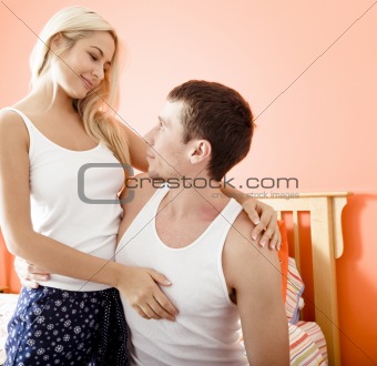 Couple Hugging in Bedroom