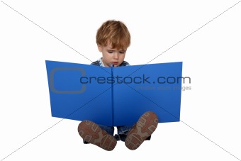 boy studying photography in a big album