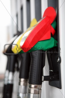 Several gasoline pump nozzles at petrol station