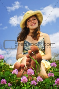 Young girl sitting on meadow
