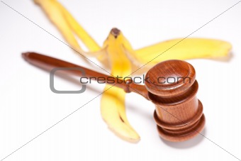 Gavel and Banana Peel on Gradated Background with Selective Focus - Lawsuit Concept.