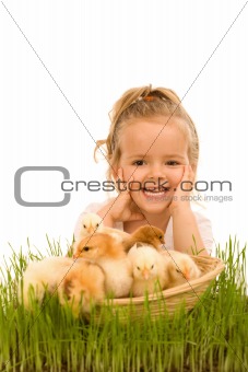 Little girl with a basket full of small chickens