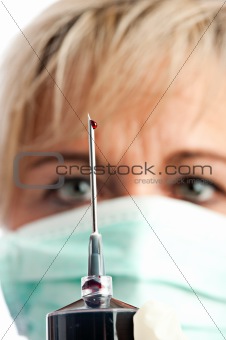 syringe needle with a drop of blood