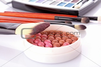 cosmetic brushes  brush , eye shadows and rouge  on the white ba