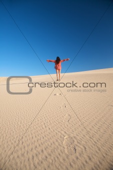 happy woman on desert dune