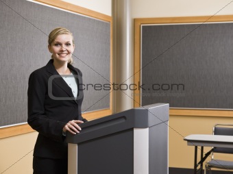 Young Woman Standing at Podium Smiling