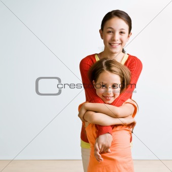 Sisters hugging	