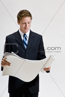 Businessman looking at blueprints