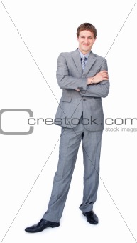 Smiling businessman standing with folded arms 
