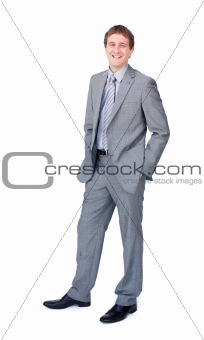 Positive businessman standing with hands in pockets 