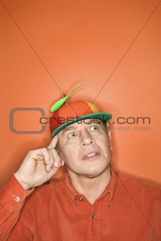 Caucasian man wearing propeller cap.