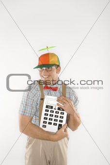 Young man dressed like nerd holding large calculator.