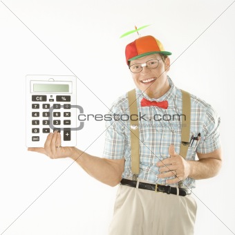 Young man holding large calculator.
