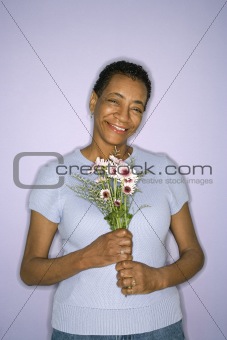 Woman holding flowers.