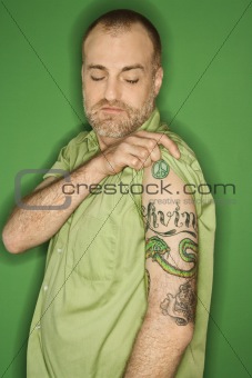 Portrait of Caucasian man showing tattoo.