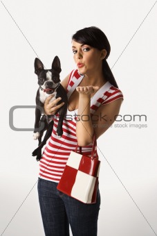 Young Caucasian woman holding Boston Terrier.