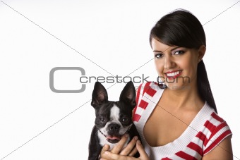 Young Caucasian woman holding Boston Terrier dog.