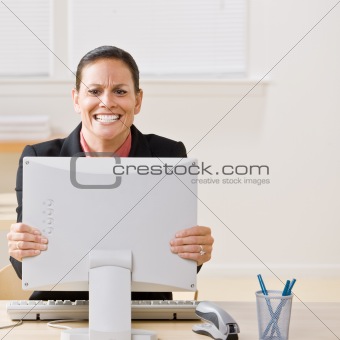 Businesswoman shaking monitor