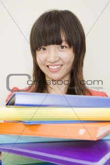 Young Woman Holding Colorful Notebooks