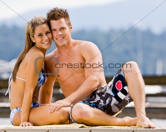 Couple sitting on pier