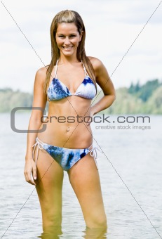 Woman wading in lake water